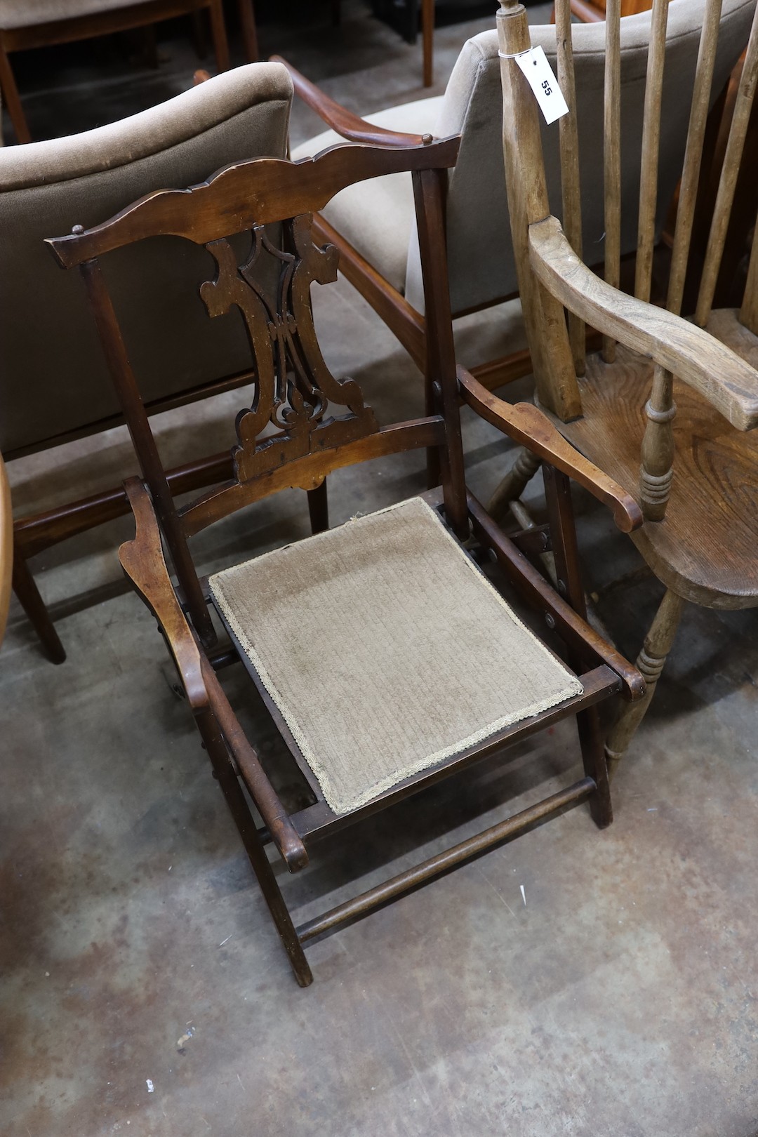 A Victorian elm and beech Windsor comb back armchair together with a late Victorian beech folding elbow chair